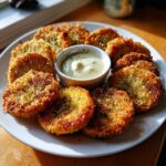 Plate of golden-brown Fried Green Tomatoes with Remoulade sauce, a Southern classic.