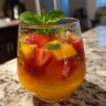 Close-up of a refreshing fruity cocktail with strawberries, mango, and mint, perfect for summer. This is one of the 20 Refreshing Fruity Cocktails.