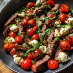 Close-up of Grilled Flank Steak Caprese with cherry tomatoes, mozzarella, and balsamic dressing.