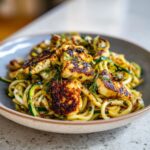 Amazing grilled halloumi zucchini pasta salad 11 Close-up of a bowl of grilled halloumi and zucchini pasta salad, a delicious and healthy dish.