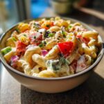 Close-up of a bowl of healthy pasta salad Greek yogurt with vegetables.