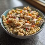 Amazing High Protein Pasta Salad 30g Protein 11 Close-up of a bowl of high protein pasta salad with chicken, vegetables, and chickpeas.
