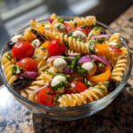 Amazing 25-min Italian pasta salad recipe 11 Close-up of a bowl of quick and easy Italian pasta salad, featuring pasta, tomatoes, mozzarella, and basil.