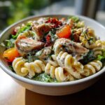 Amazing Pasta Salad and Chicken: 1 Quick Recipe 11 Close-up of a pasta salad and chicken bowl with tomatoes, lettuce, and creamy dressing.