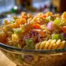 Close-up of a delicious pasta salad classic with rotini pasta, vegetables, and creamy dressing.