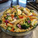 Amazing Pasta Salad Easter: 100% Delicious Flavor 11 A large bowl of pasta salad Easter with rotini pasta, vegetables, and hard-boiled eggs.