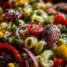 Close-up of a vibrant pasta salad high protein with vegetables and herbs.