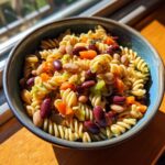 Pasta salad kidney beans in a blue bowl, featuring rotini pasta, kidney beans, and vegetables.