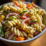 Perfect Pasta Salad: 5 Simple Steps 11 Close-up of a bowl of pasta salad with spiral pasta, vegetables, and herbs. How do you make pasta salad?