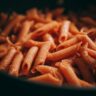 Close-up of cooked penne pasta, ready for making pasta salad. Learn how do you make pasta salad.