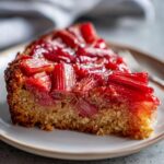 A slice of delicious Rhubarb Upside Down Cake on a plate, showing the caramelized rhubarb topping.