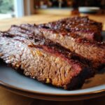 Close-up of perfectly smoked brisket with a delicious dry rub, ready to eat.