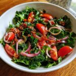 Close-up of a Spring Mix Salad with Balsamic Honey Dressing, tomatoes, and red onion.
